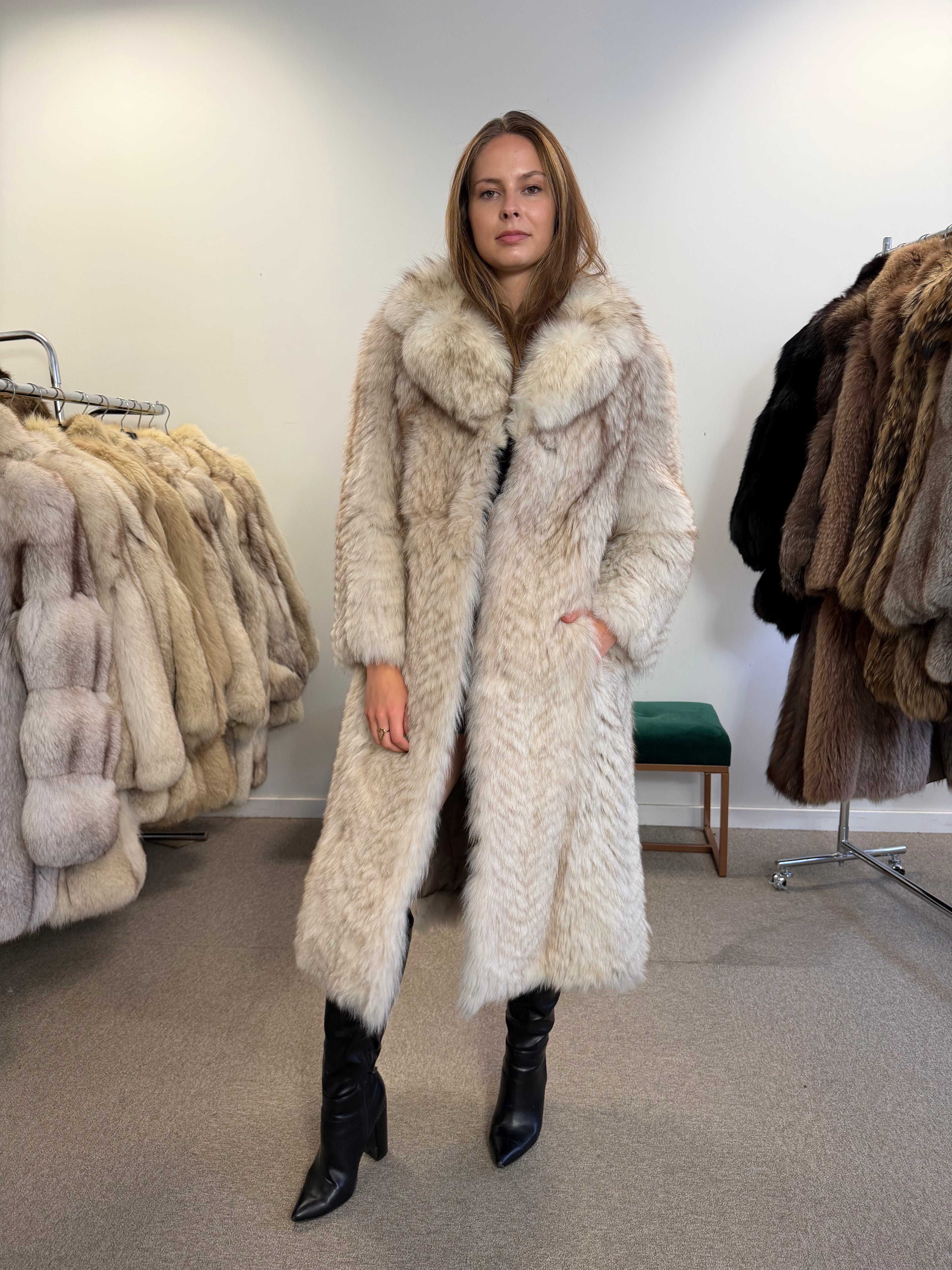 Model wearing a full-length white Nordic fox fur coat, front view