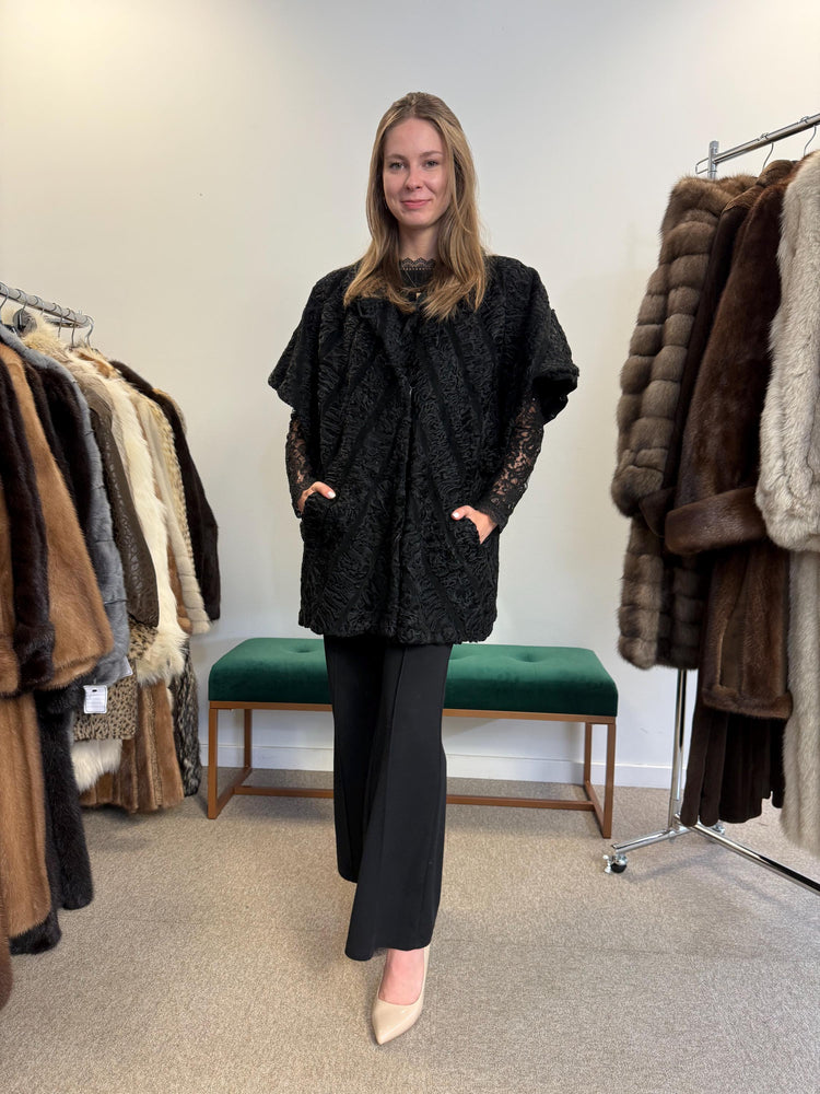 Real black astrakhan fur vest, women’s, vintage rare find, high-quality fur, back view.
