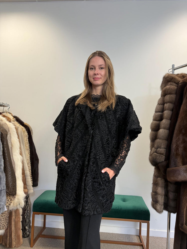 Black astrakhan fur vest, real fur, women’s, soft high-quality vintage vest, front view.