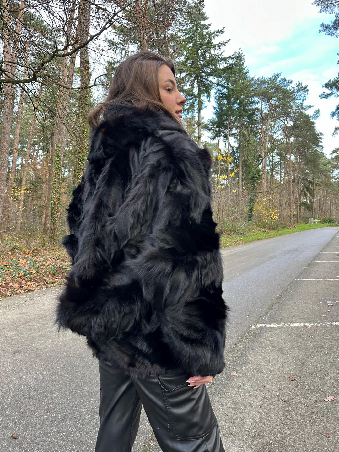 Close-up of thick black fox fur texture, women’s large jacket, soft luxurious real vintage fur.