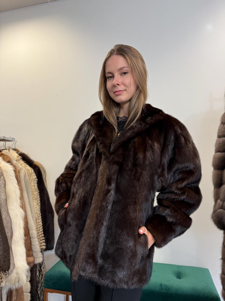 Front view of women’s medium short brown mink fur jacket, real soft thick vintage fur.