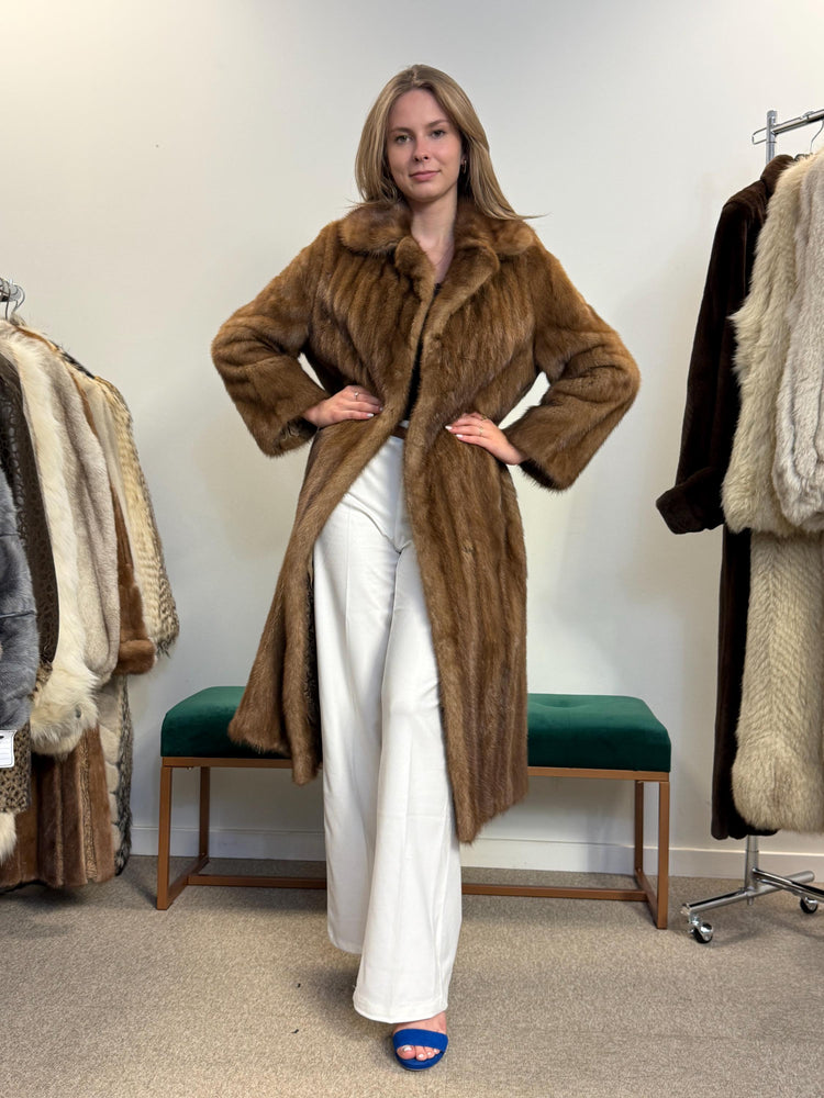 Women’s large pastel brown mink coat worn closed, high-quality fur, elegant vintage style.