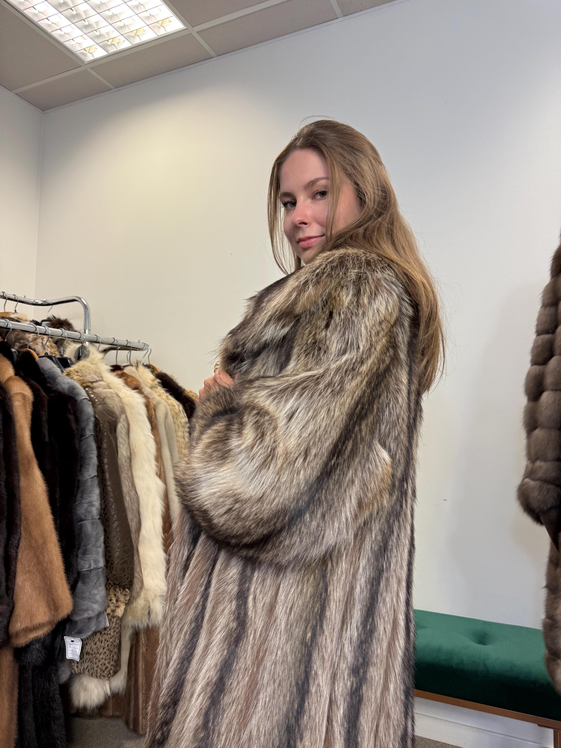 Women’s raccoon fur coat worn closed, large size, soft thick fur, full-length vintage style.