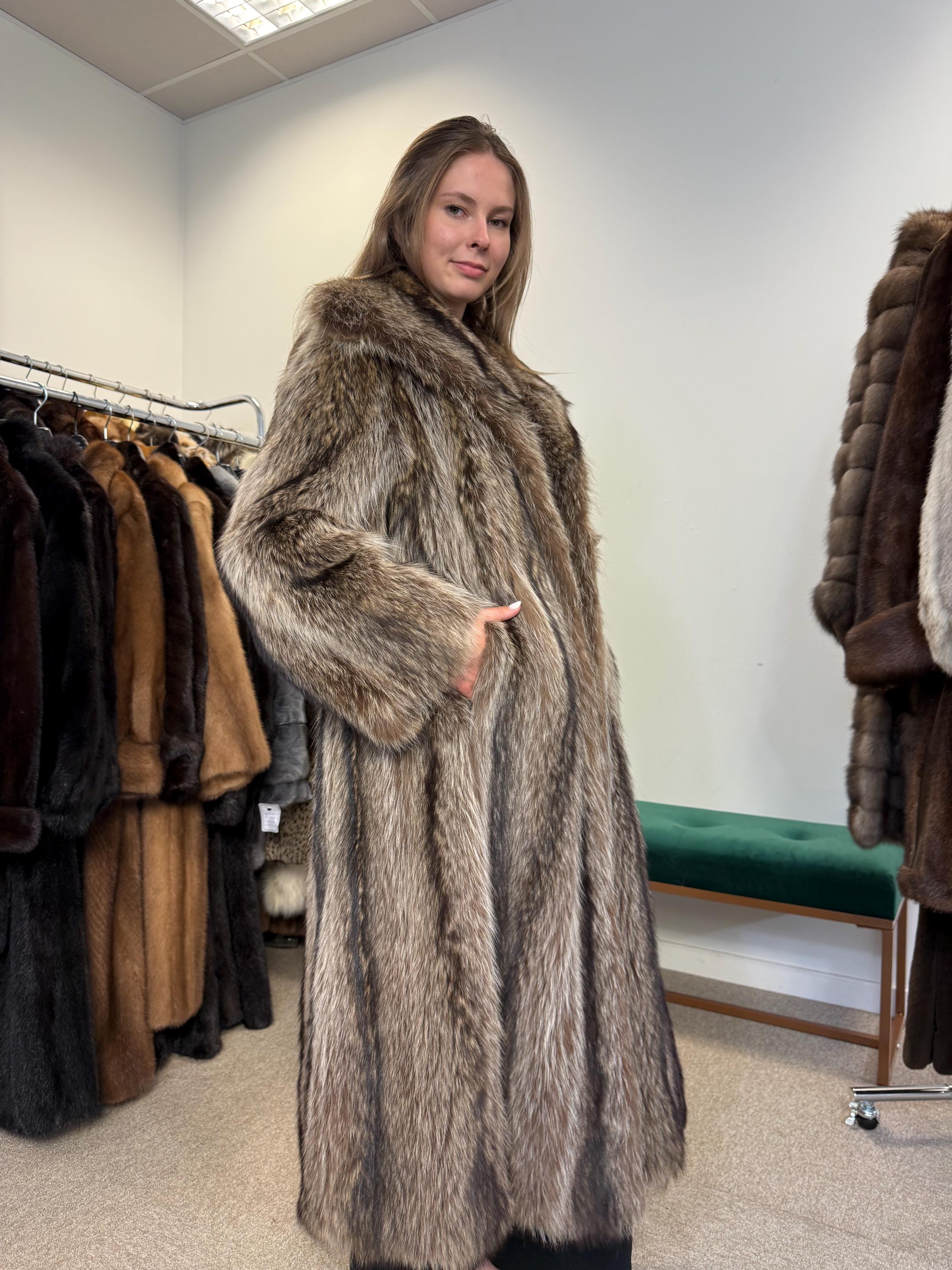 Close-up of soft thick raccoon fur, natural colour, large women’s coat, vintage high-quality fur.