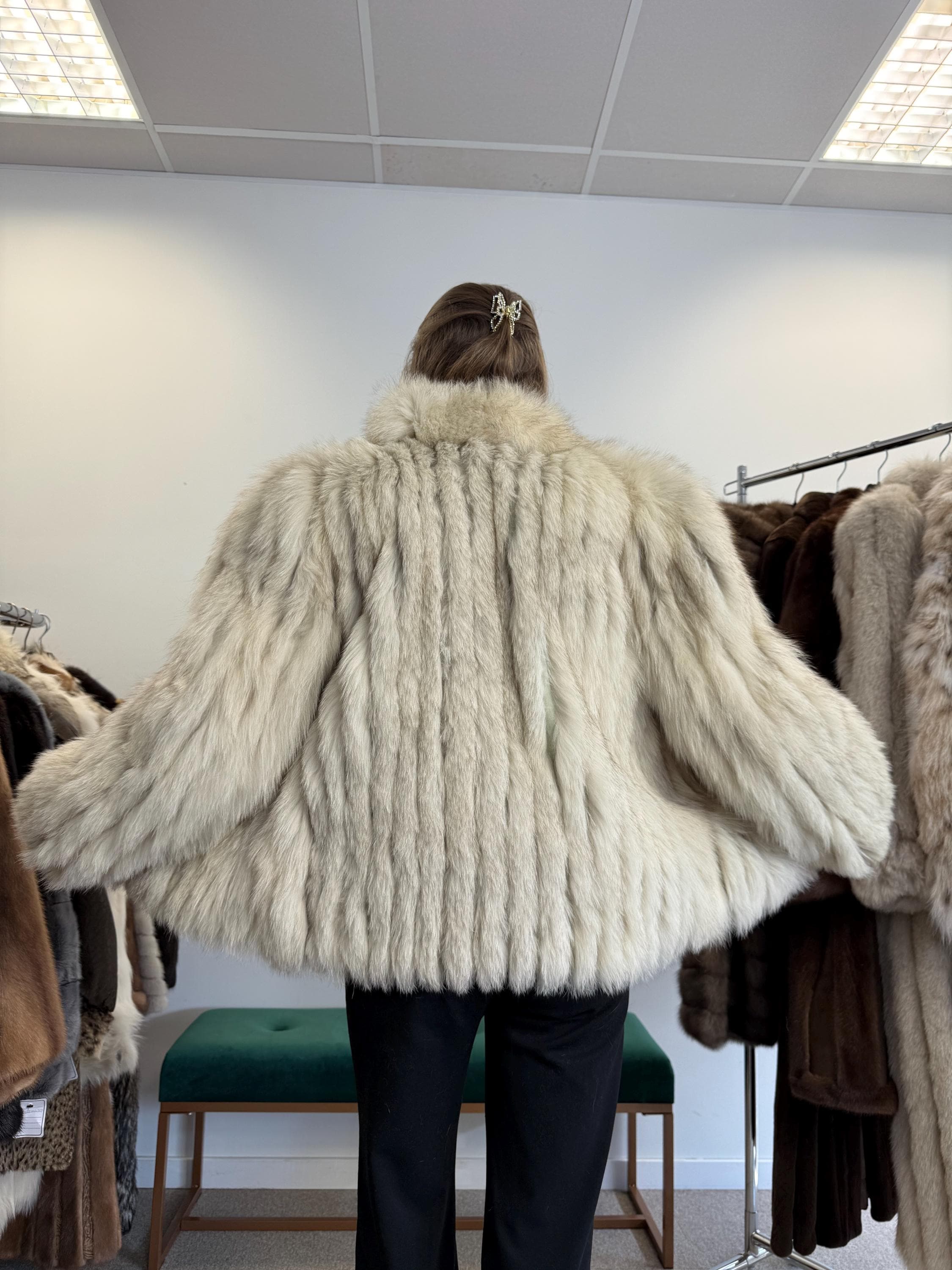 Close-up of Saga Fox fur texture, soft white and blue natural fur, medium women’s jacket.